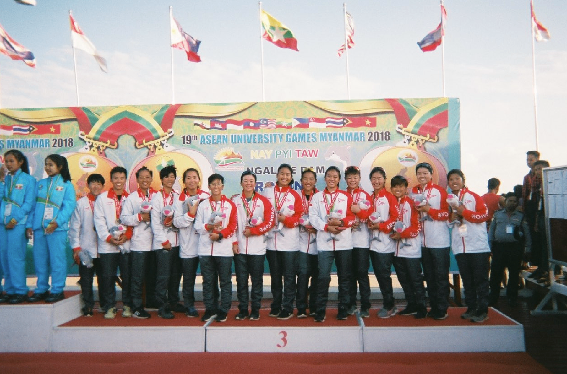 Singapore team celebrating on the podium at the 2018 ASEAN University Games